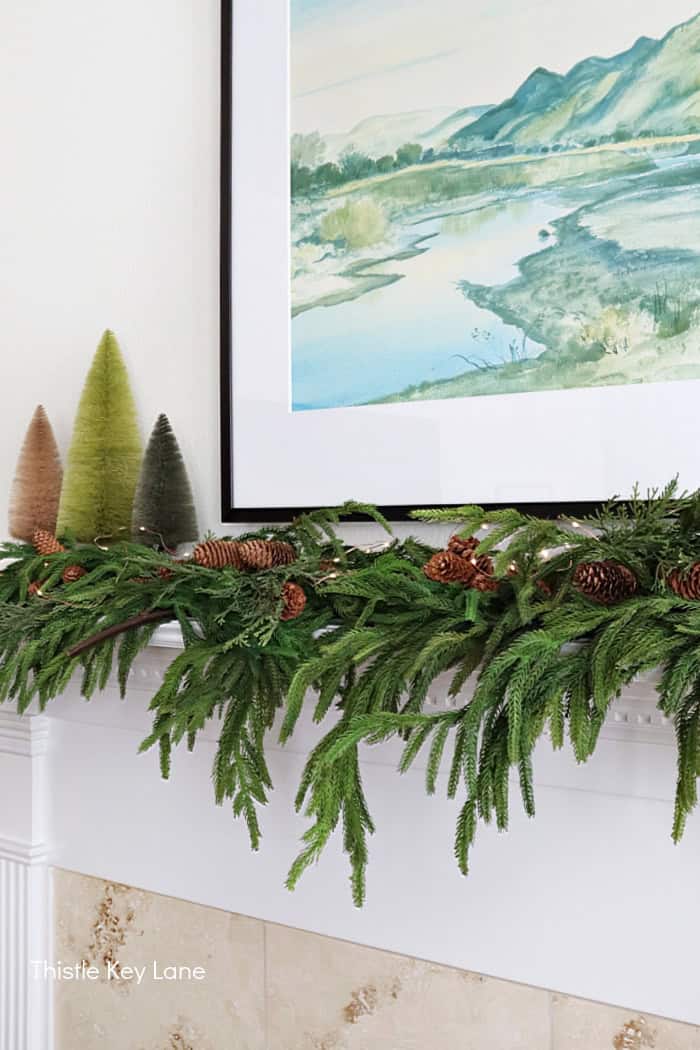Norfolk pine garland and pinecones on mantel. Country Cottage Christmas Home Tour.