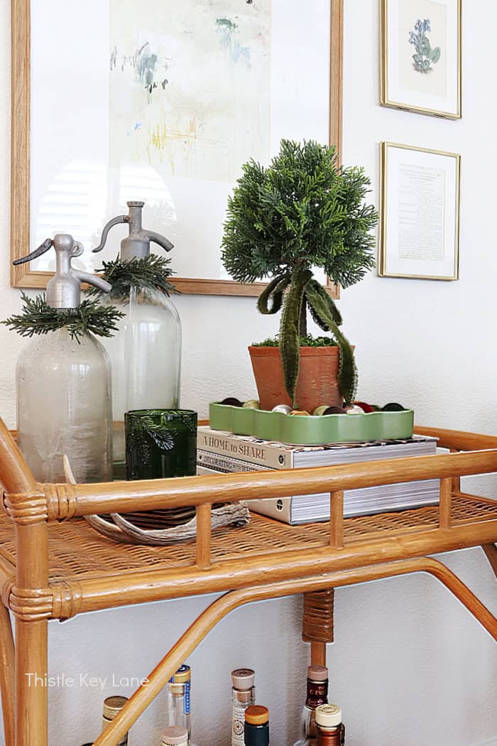 Topiary with ribbon and vintage bottles.