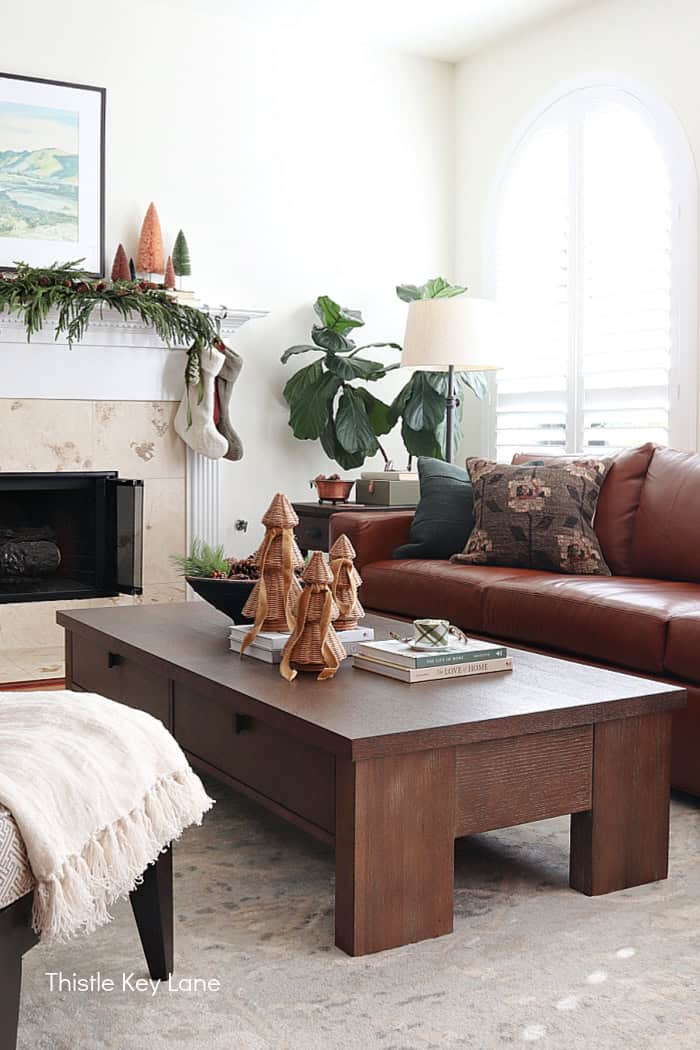 Large coffee table and leather sofa with holiday decorations. Country Cottage Christmas Home Tour.