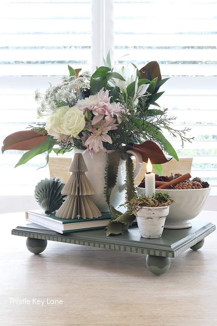 Riser with feet with flower arrangement and bowl. Holiday Floral Vignette With DIY Flameless Candle Holder.