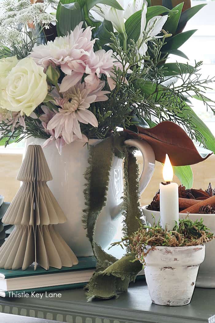 Candle, tree ornaments and flowers. Holiday Floral Vignette With DIY Flameless Candle Holder.