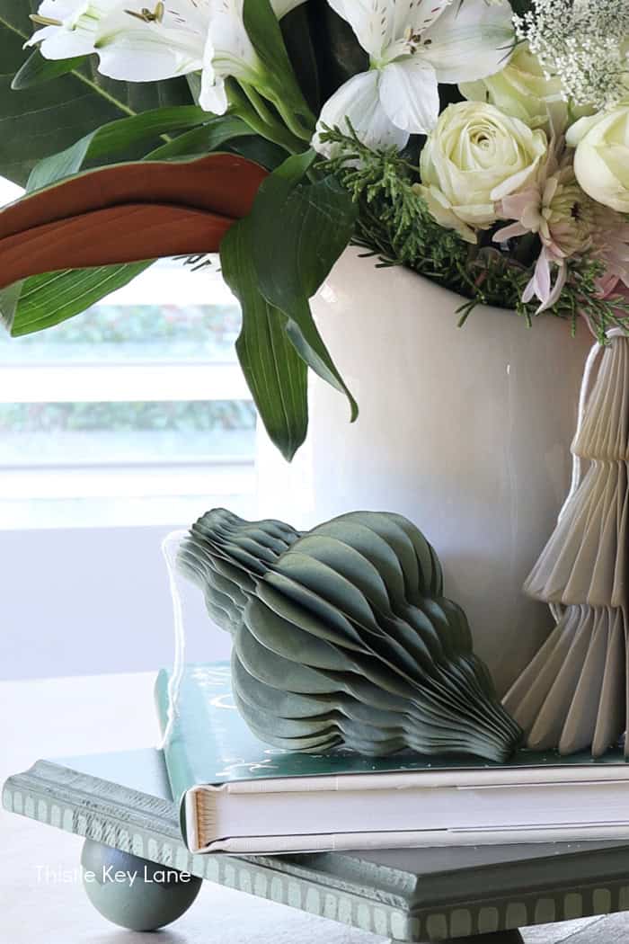 Paper ornaments on a tray. Holiday Floral Vignette With DIY Flameless Candle Holder.