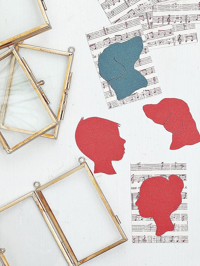 Assembling silhouette ornaments in frames with music paper background. DIY Silhouette Keepsake Ornaments.