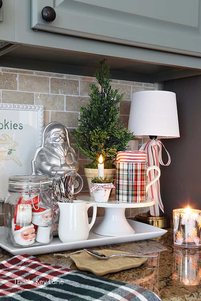 Plaid coffee mugs, lamp and faux cedar tree. Simple Vintage Holiday Kitchen Ideas.