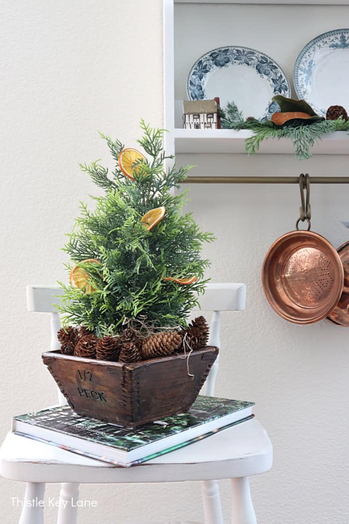 Table top tree with dried orange slices and pinecones. Simple Vintage Holiday Kitchen Ideas.