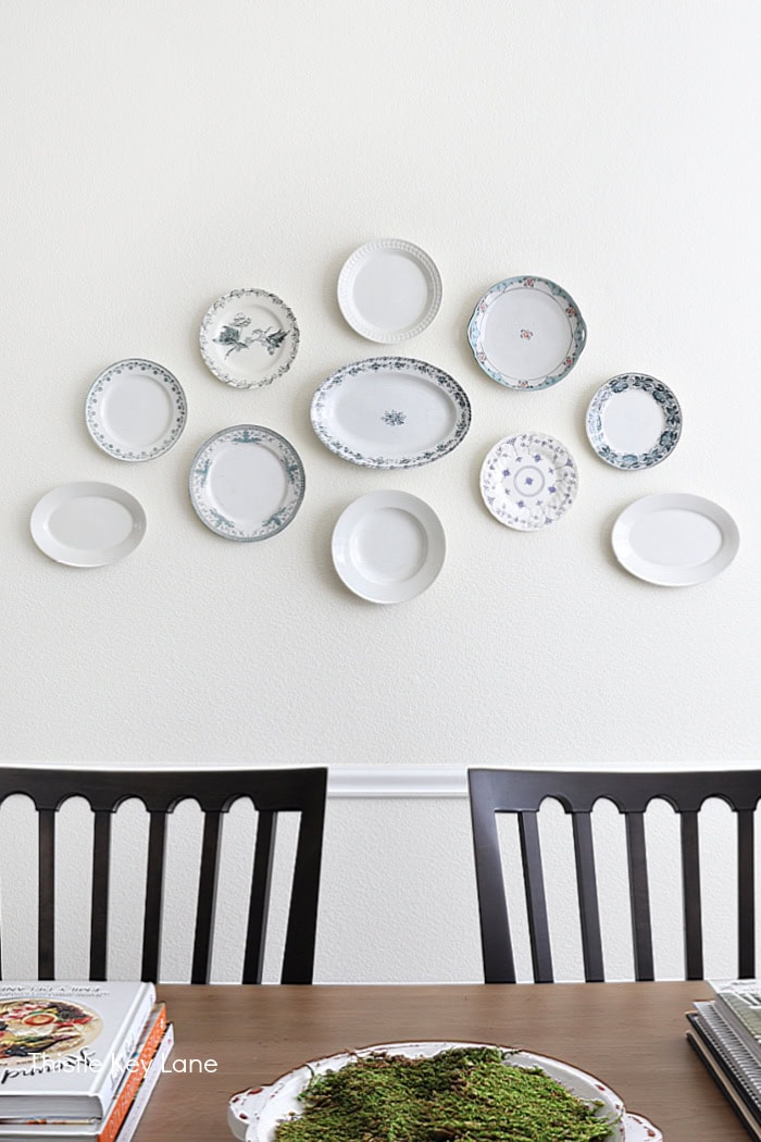 Plate gallery wall in the dining room. Floral Spring Vignette For Buffet Or Sideboard.