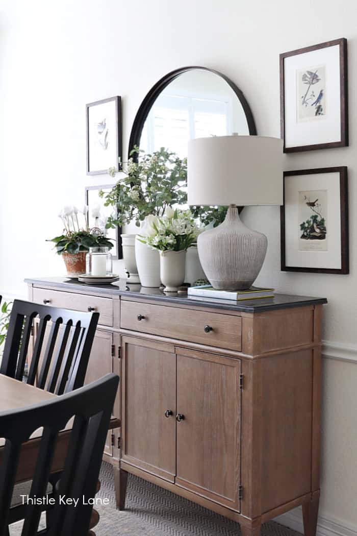 Buffet table, with mirror and artwork. Floral Spring Vignette For Buffet Or Sideboard.