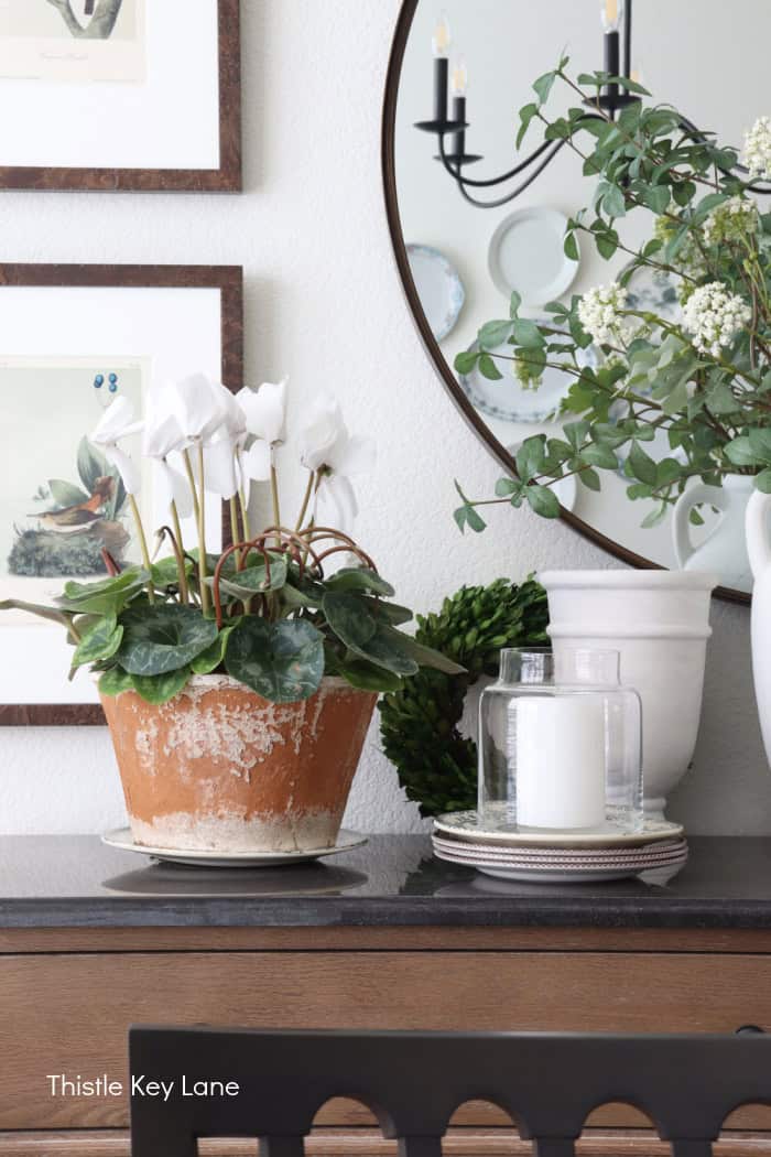 Layering vases and accents on a table. Floral Spring Vignette For Buffet Or Sideboard.