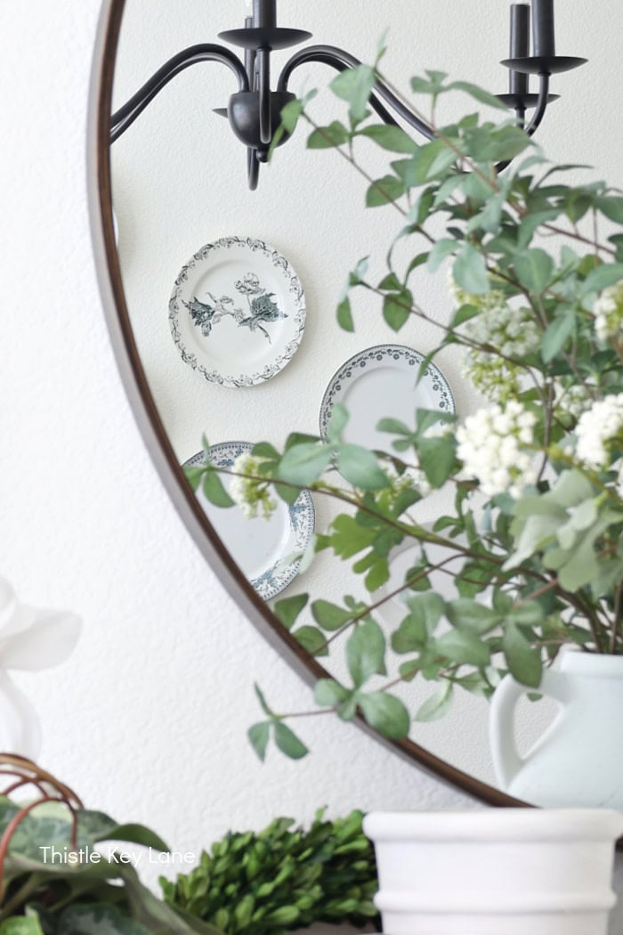 Plates on the wall reflected in the mirror.