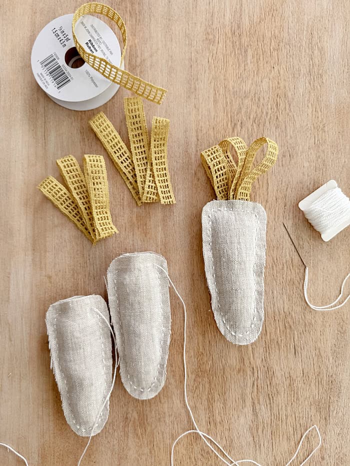 Carrots with lace ribbon for stems. DIY Lace Bunny And Carrot Pillows.