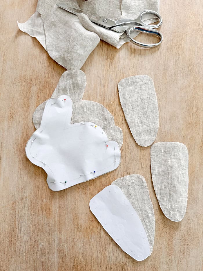 Using patterns to cut out fabric.