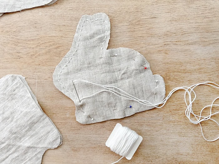 Stitching bunny shape with embroidery thread.