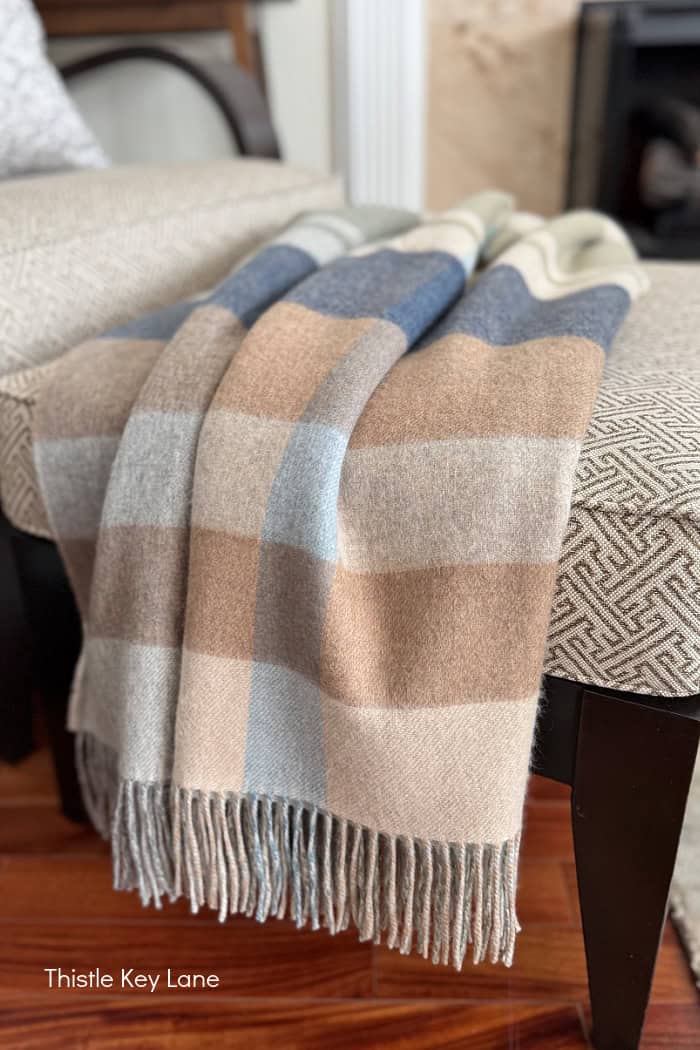 Cashmere plaid throw in soft colors.