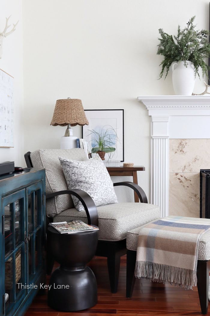 Arm chair with console table artwork and pillow. Winter To Spring Transitional Styling.