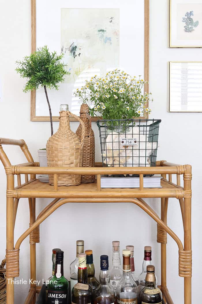 Bar cart, wire basket, wicker bottles. How To Decorate With A Wire Basket.