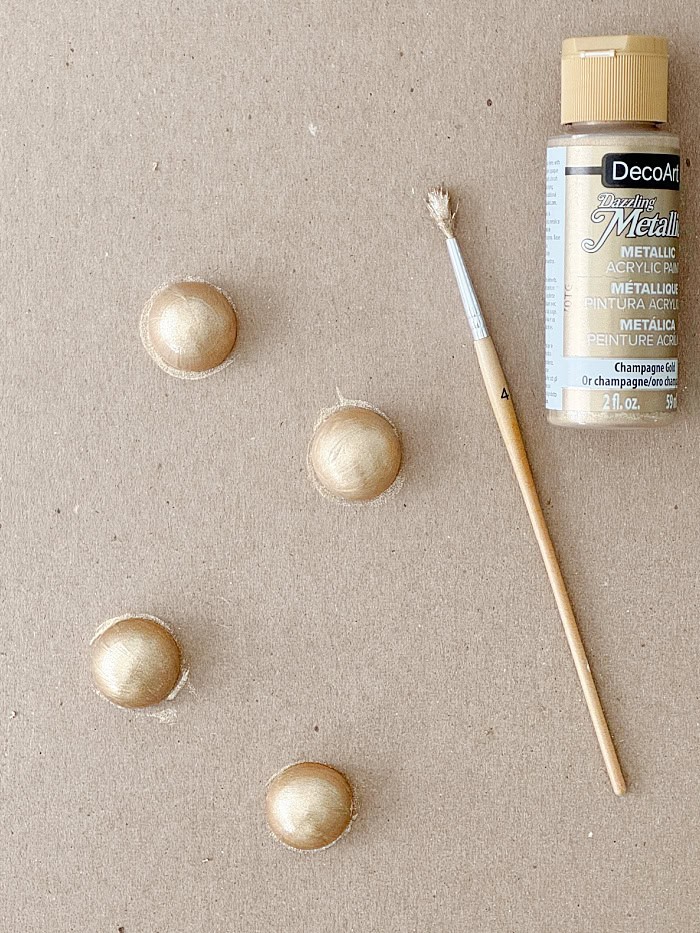 Painting half round balls to use as tray feet. How To Decorate A Tray With Wallpaper.