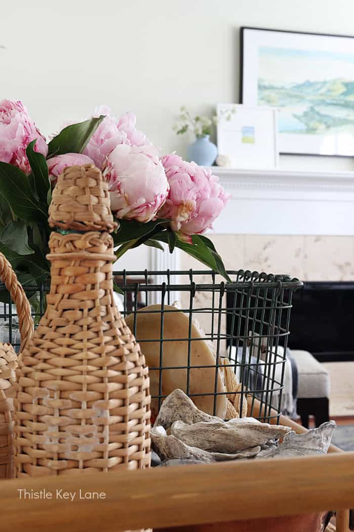 Pink flowers, shells and wicker bottle.