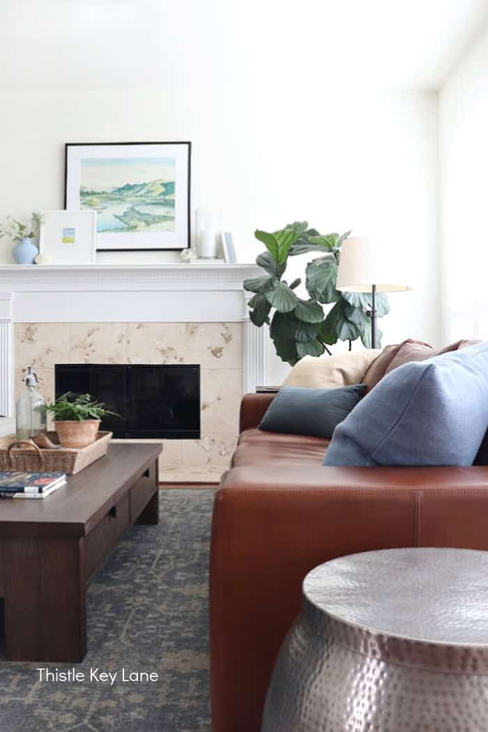 Leather sofa with blue pillows. Coastal Family Room Styling.