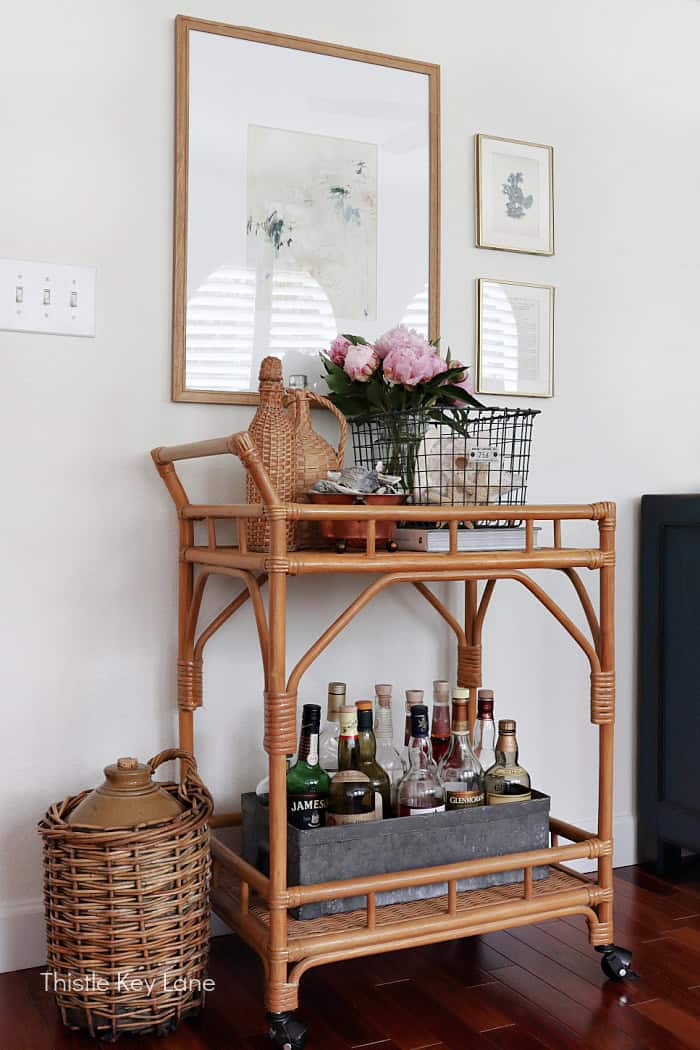Rattan bar cart with vintage collections. Coastal Family Room Styling.