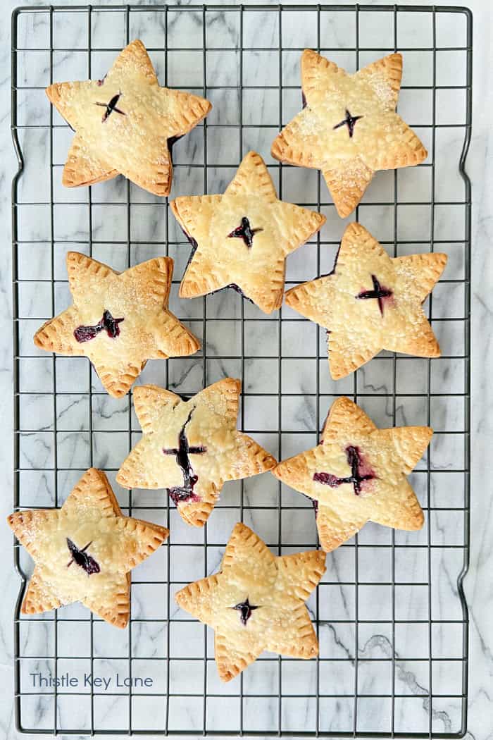 Star hand pies cooling on a wire rack. Star Blueberry Hand Pies Recipe.