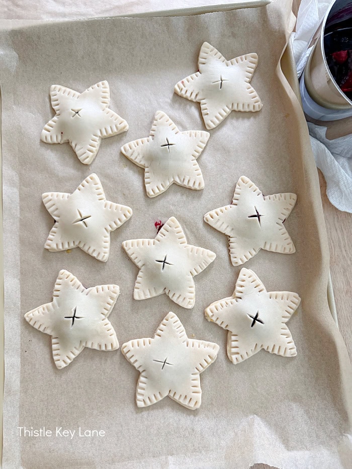 Assembling star hand pies before baking.