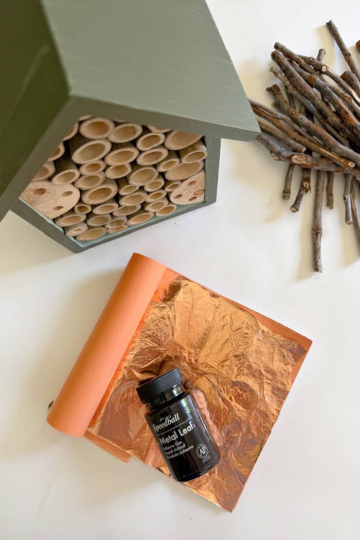 Bee house painted green and supplies to finish the makeover. Create A Fancy Bee Hotel.