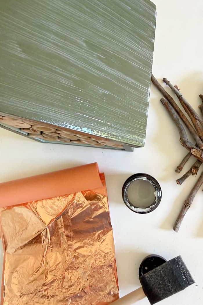 Adding copper leafing to the bee house. Create A Fancy Bee Hotel.