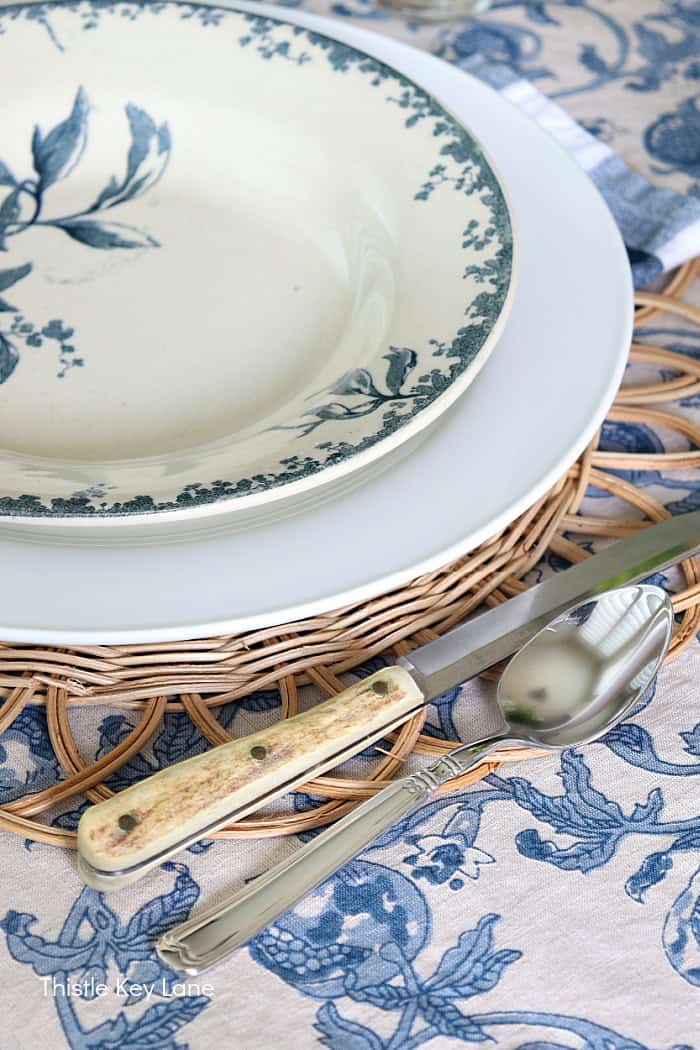 Vintage antler knife at a place setting. French Country Style Table Setting.