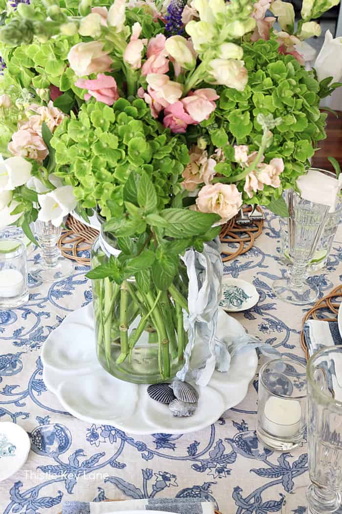 Glass jar vase with flowers. French Country Style Table Setting.