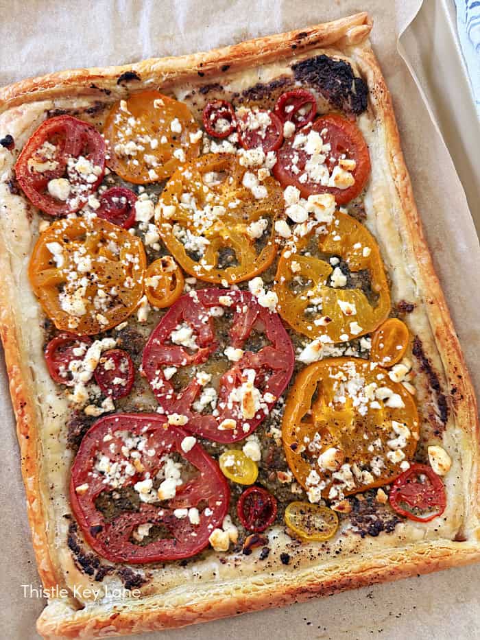 Yellow and red tomatoes with cheese. Tomato Pesto Puff Pastry Tart.