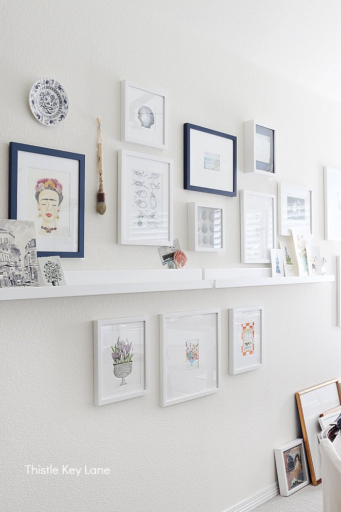 Gallery wall in a studio. DIY Painted Shell Artwork.
