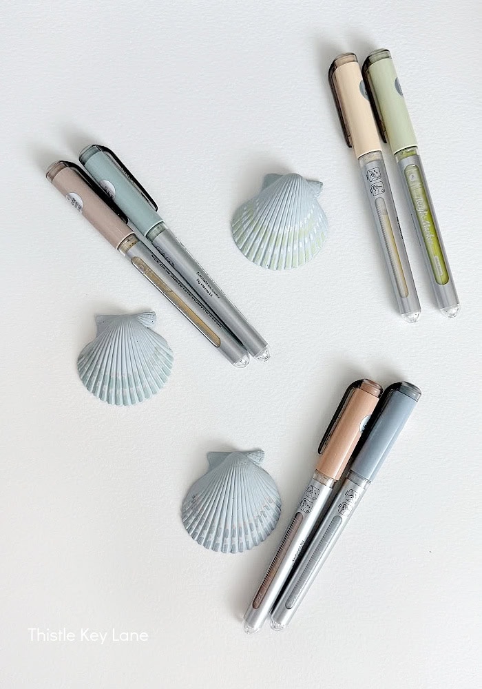 Adding details to shells with paint pens. DIY Painted Shell Artwork.