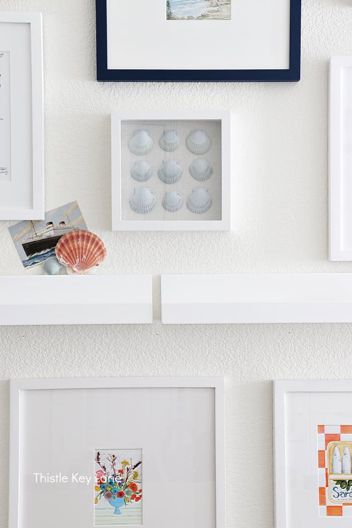 Shadow box with shells with other artwork. DIY Painted Shell Artwork.