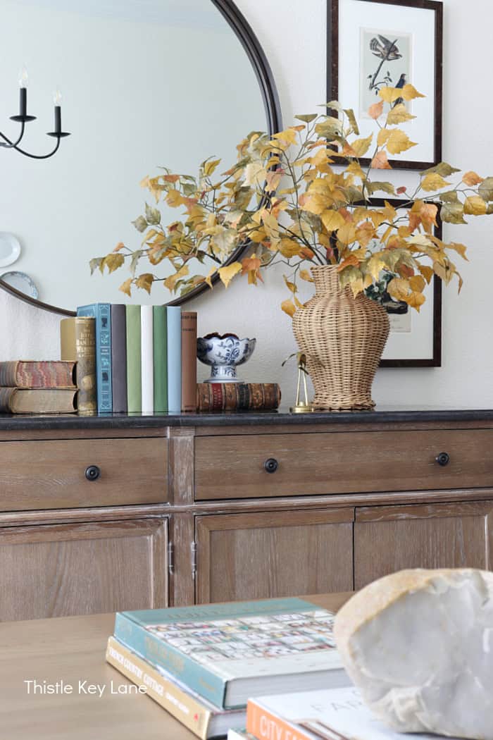 Front view of buffet with mirror and fall decor. Summer To Fall Sideboard Styling.