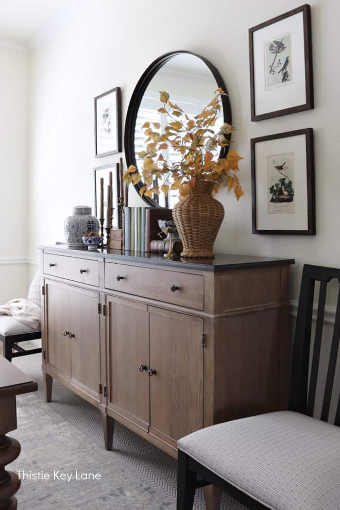 Side view of buffet with fall decor. Summer To Fall Sideboard Styling.