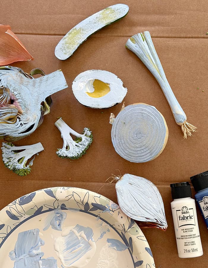 Sliced vegetables with paint on the flat side. DIY Vegetable Stamped Apron.