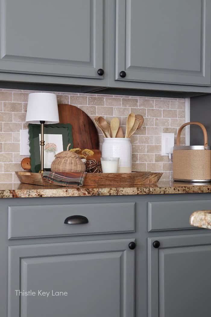 View of cabinets and counter with fall decor.