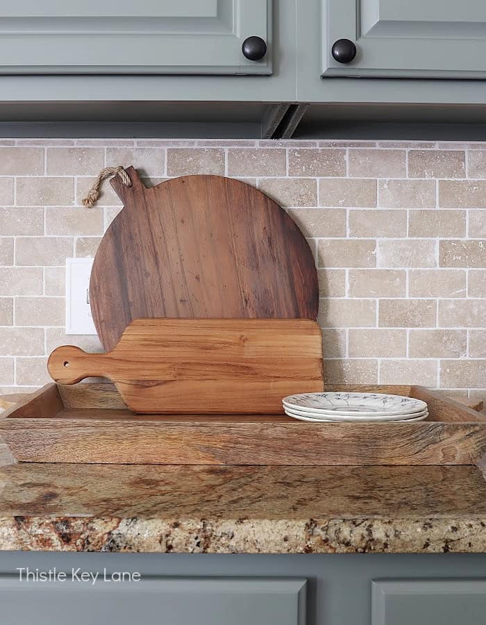 Cutting boards and plates on a tray.