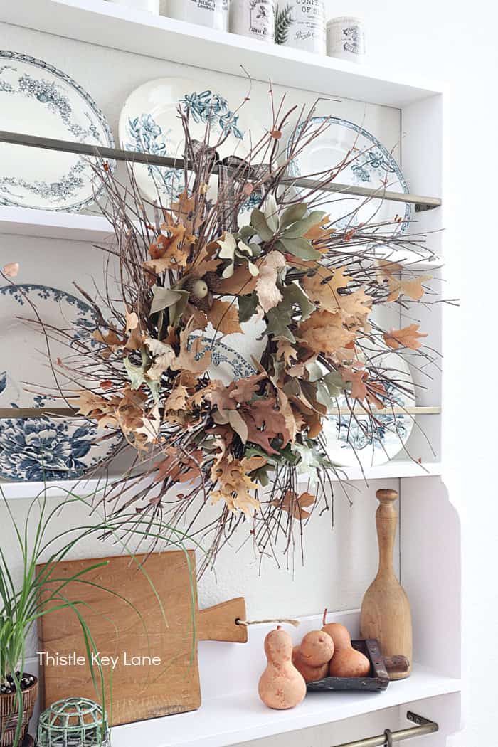 Decorating a plate rack with a fall wreath. Foraged Leaf Wreath DIY.