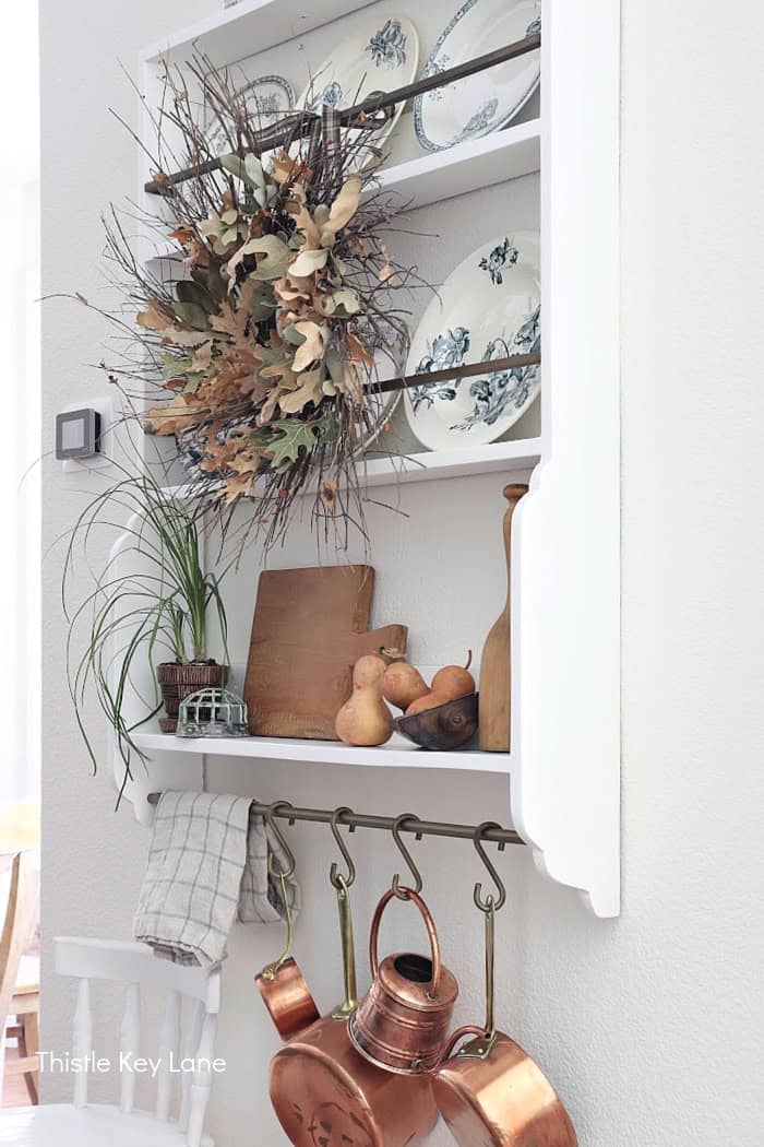Side view of plate rack with fall leaf wreath. Foraged Leaf Wreath DIY.