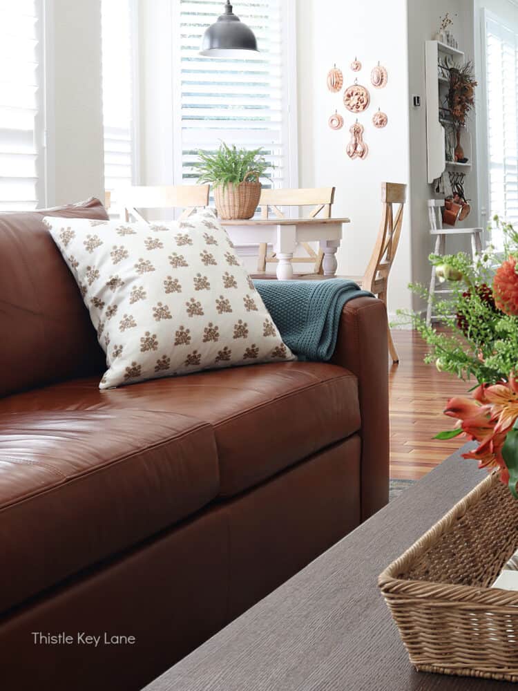 Block print pillow on a leather sofa.