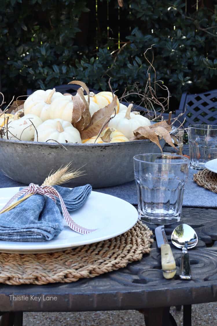 Metal tub with pumpkins and leaves. Charming Rustic Fall Al Fresco Tablescape Ideas.