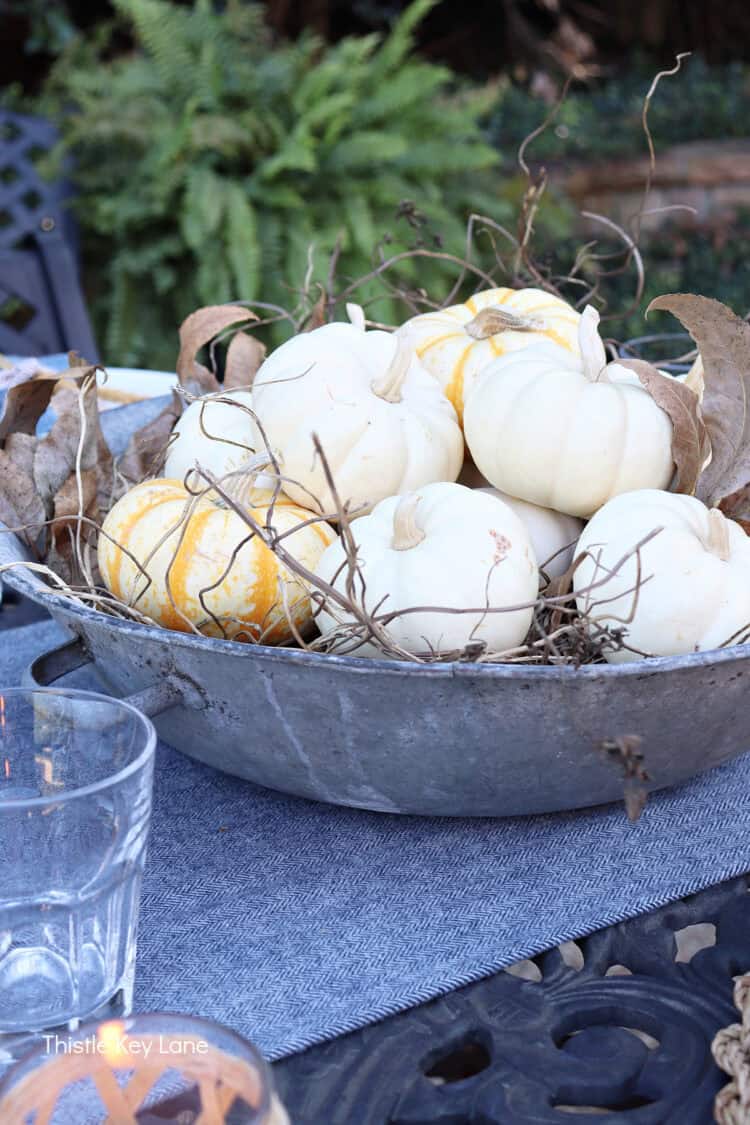 Blue table runner with pumpkin centerpiece. Charming Rustic Fall Al Fresco Tablescape Ideas.