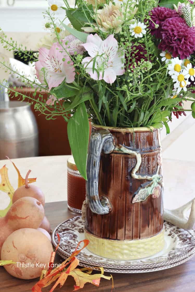 Back of majolica pitcher with flowers.
