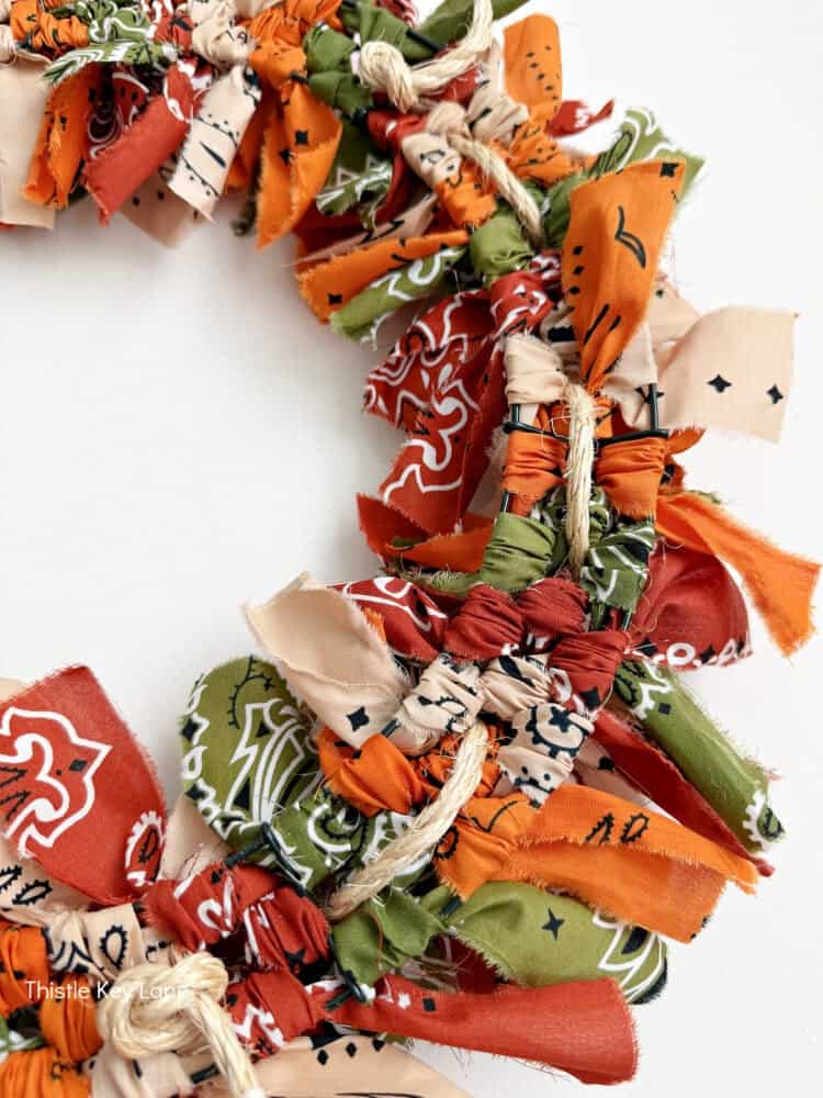 Weaving rope through the bandana fabric strips. Create A Fall Rope And Bandana Wreath.