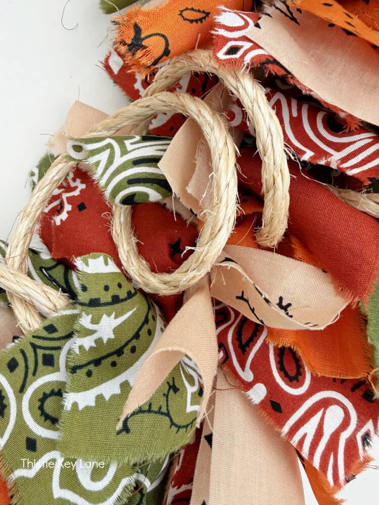 Curly loops of rope to decorate wreath. Create A Fall Rope And Bandana Wreath.